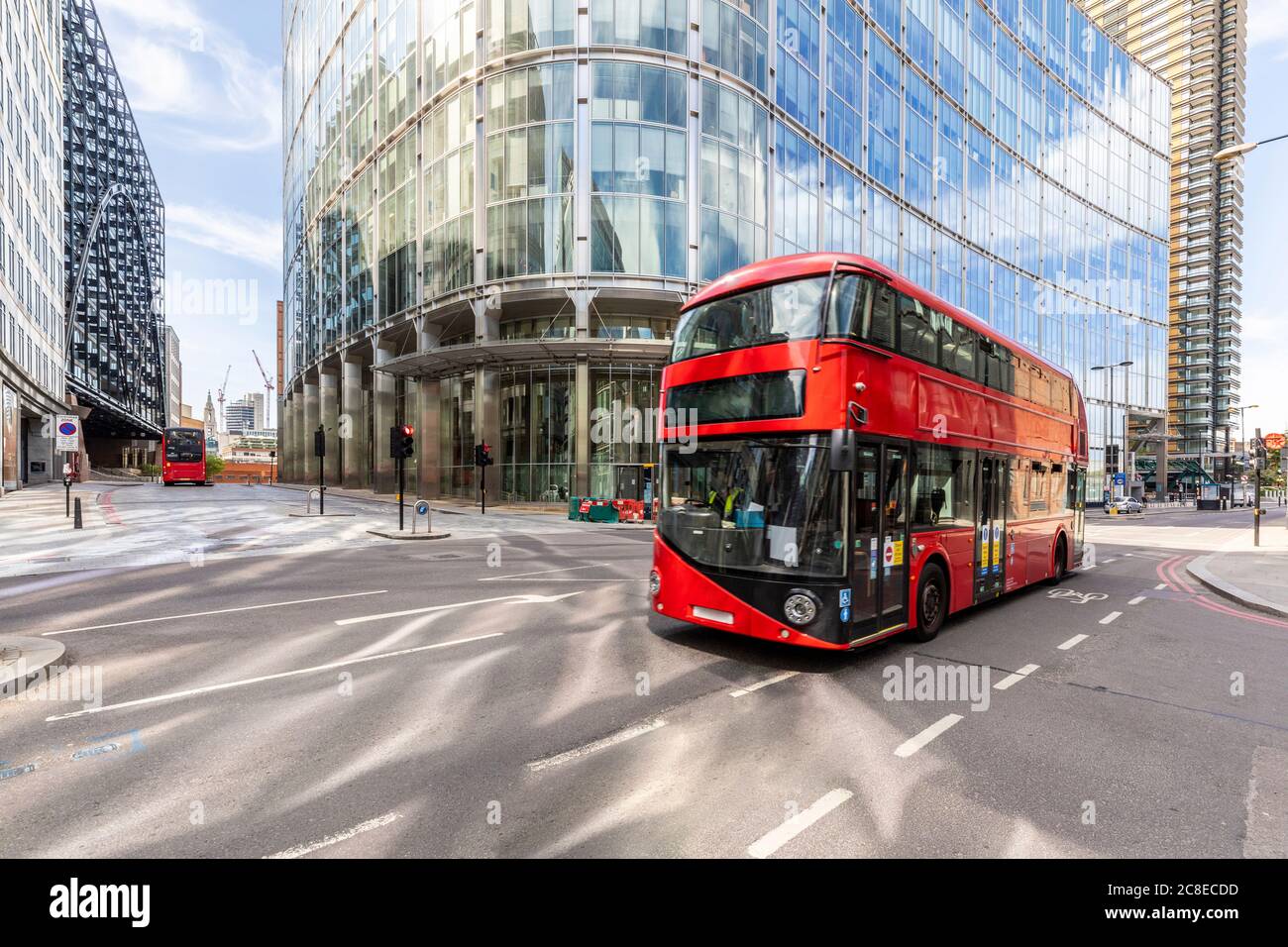 UK, London, Red double decker bus # with modern buildings in background Stock Photo