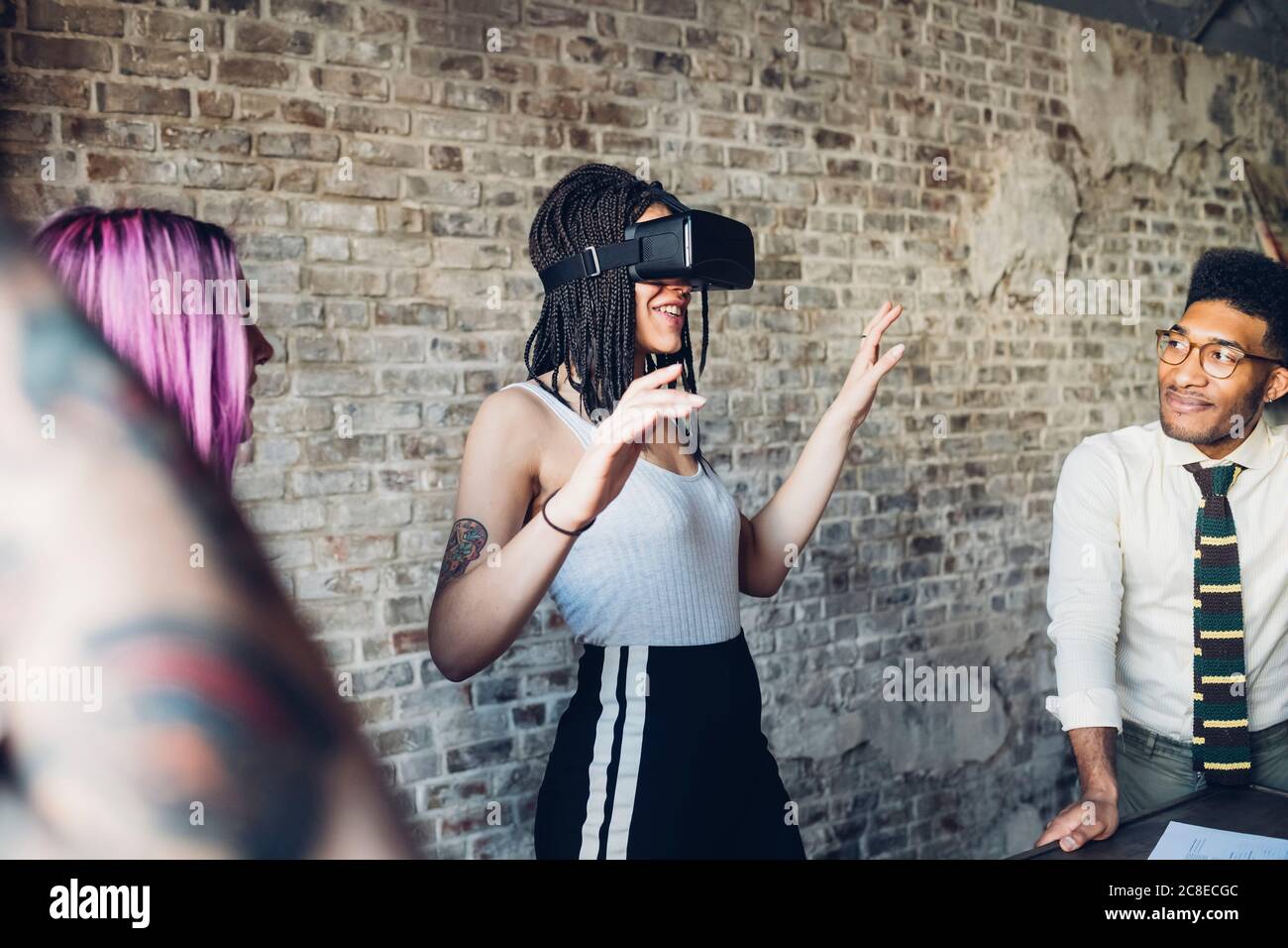 Creative team using Vr goggles in loft office Stock Photo
