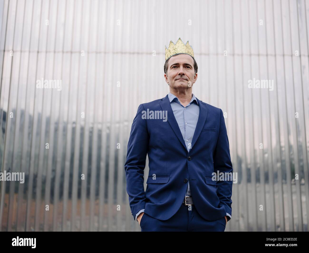 Portrait of a confident mature businessman wearing a toy crown Stock Photo