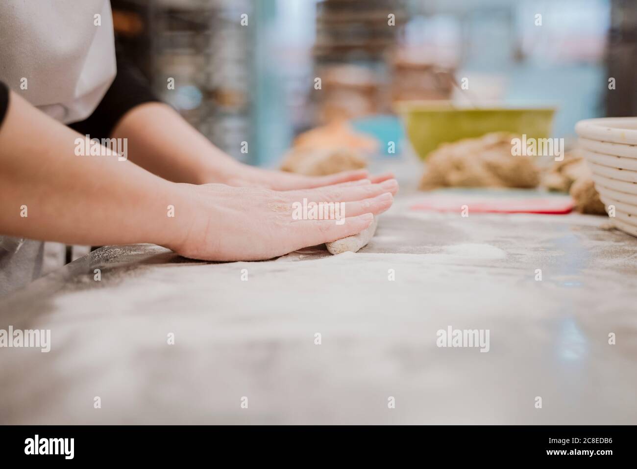 Female baker woman kneading dough hi-res stock photography and images