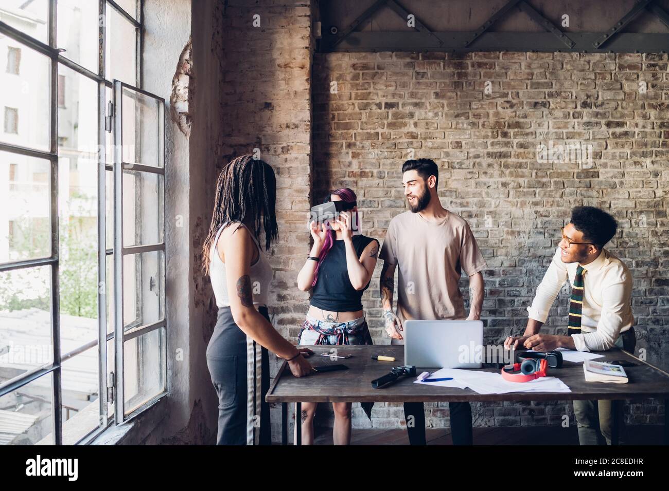 Creative team using Vr goggles in loft office Stock Photo