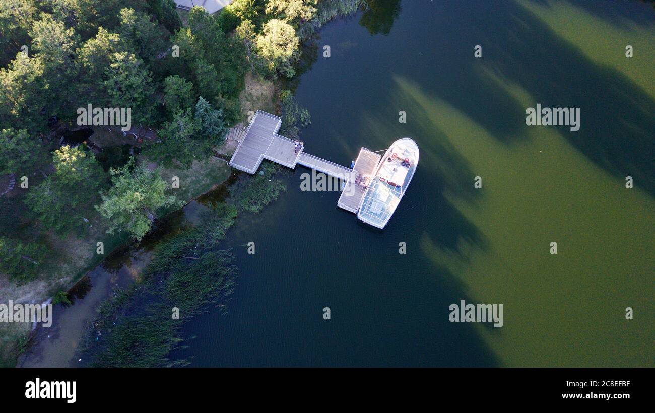 Aerial view of boat attached to the pier at the sunset Stock Photo