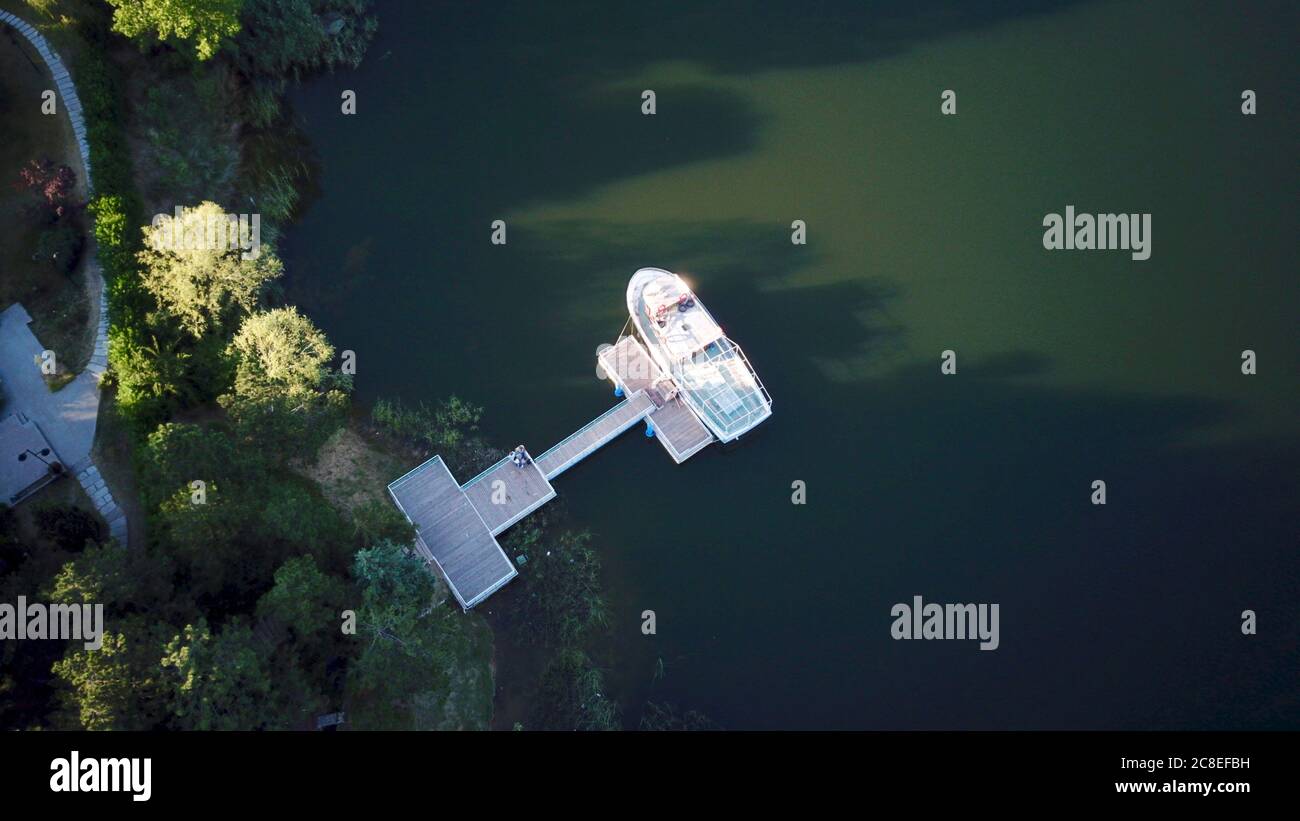 Aerial view of boat attached to the pier at the sunset Stock Photo