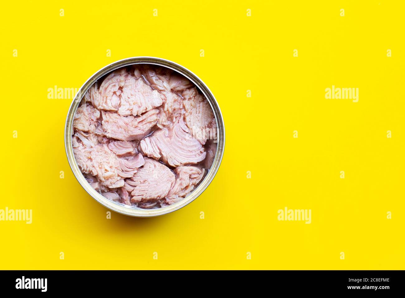 Canned tuna fish on yellow background. Copy space Stock Photo Alamy