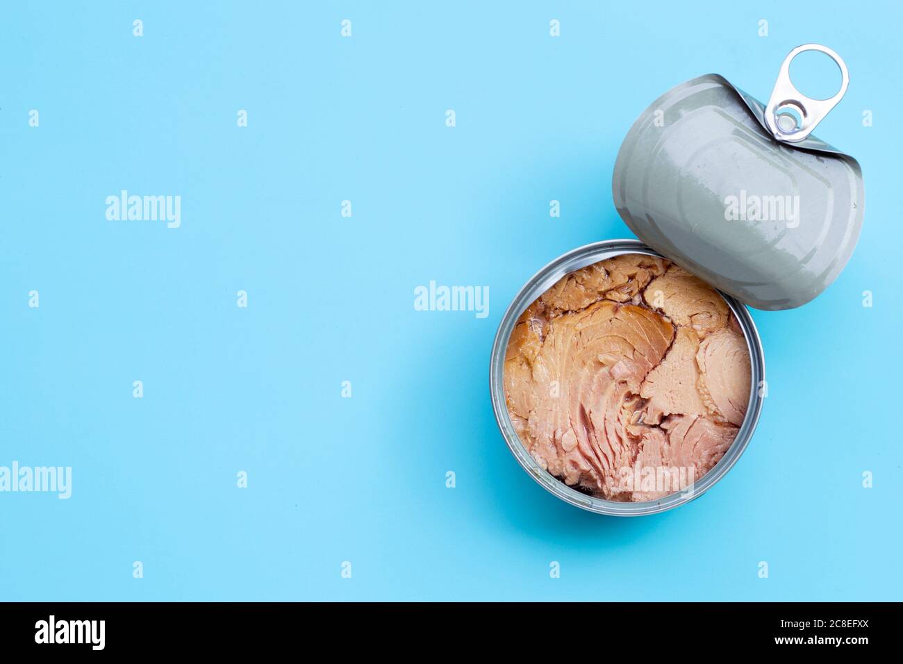 Canned tuna fish on blue background. Copy space Stock Photo Alamy