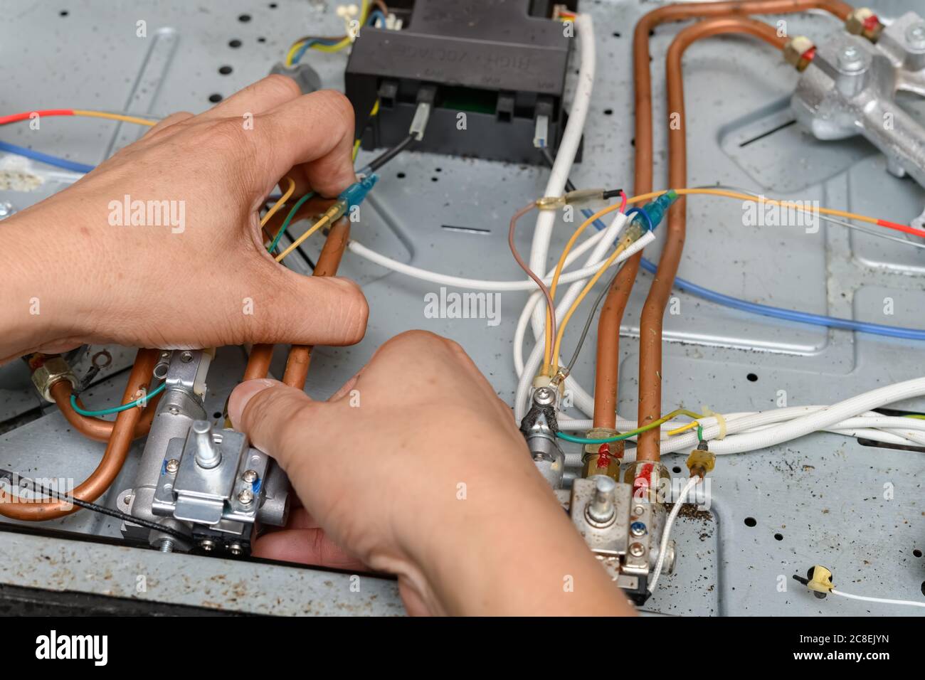man fixing a gas cooker Stock Photo