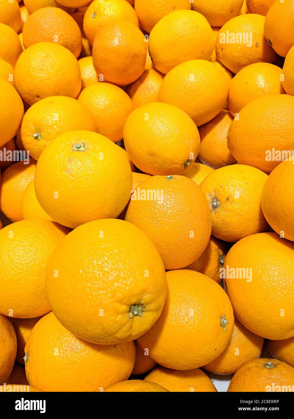oranges under the bright light in the supermarket Stock Photo Alamy