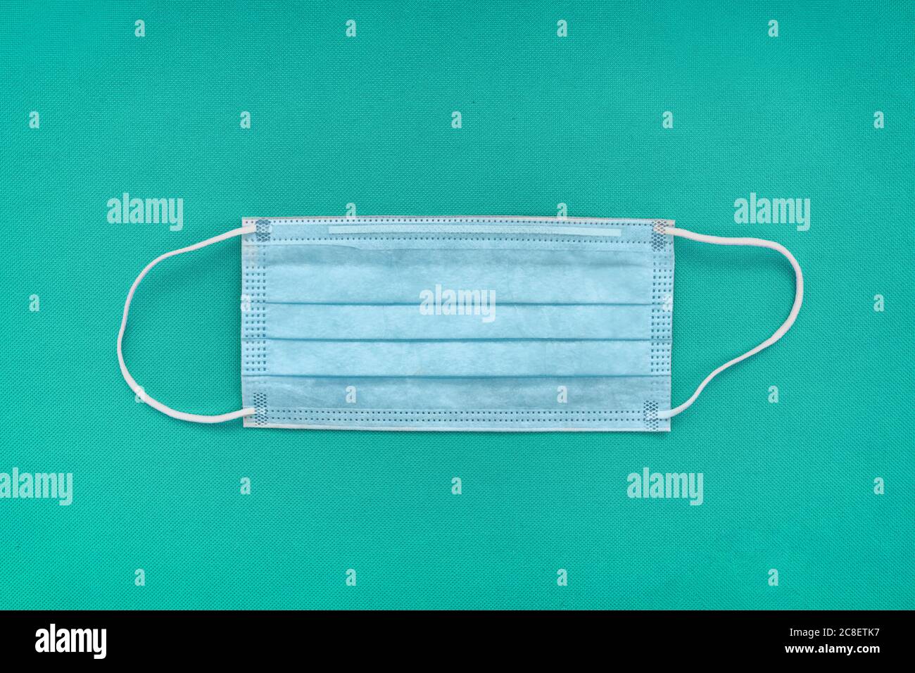 COVID19 face masks top view on hospital teal medical blue background