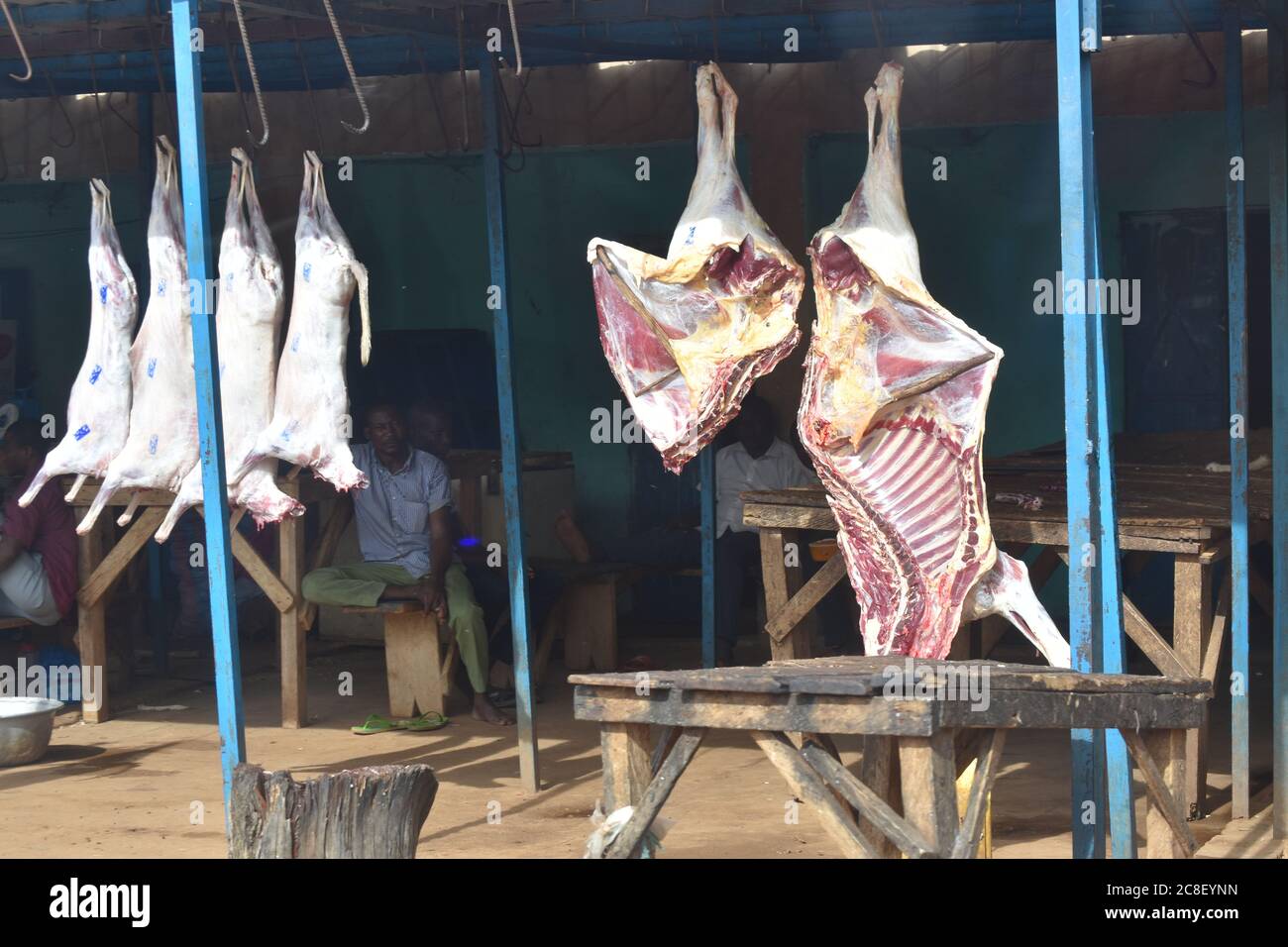 Freshly butchered beef and mutton hanging in an outdoor meat market in