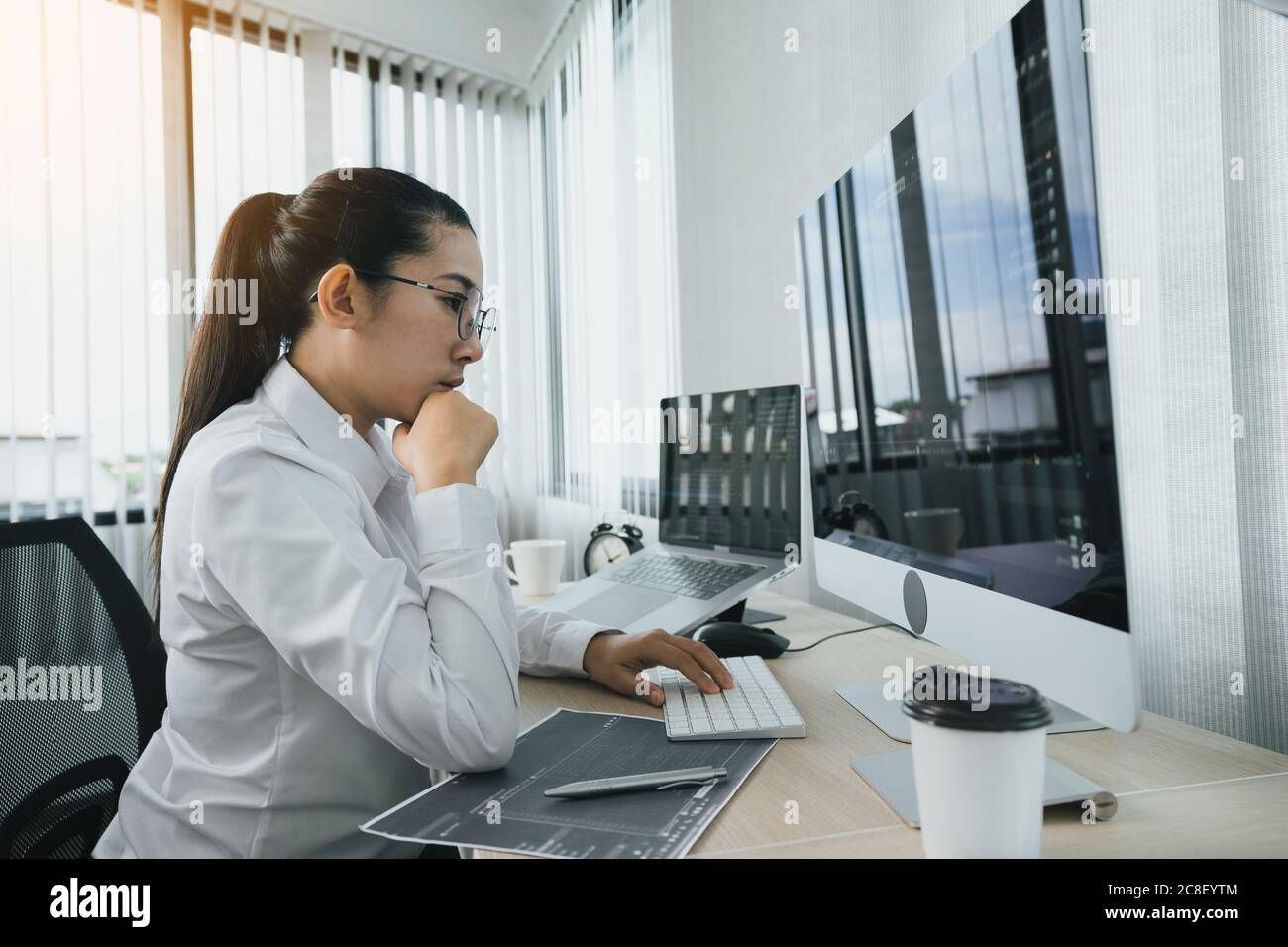 Asian female software developers are stressed in analyzing code-based systems. Stock Photo