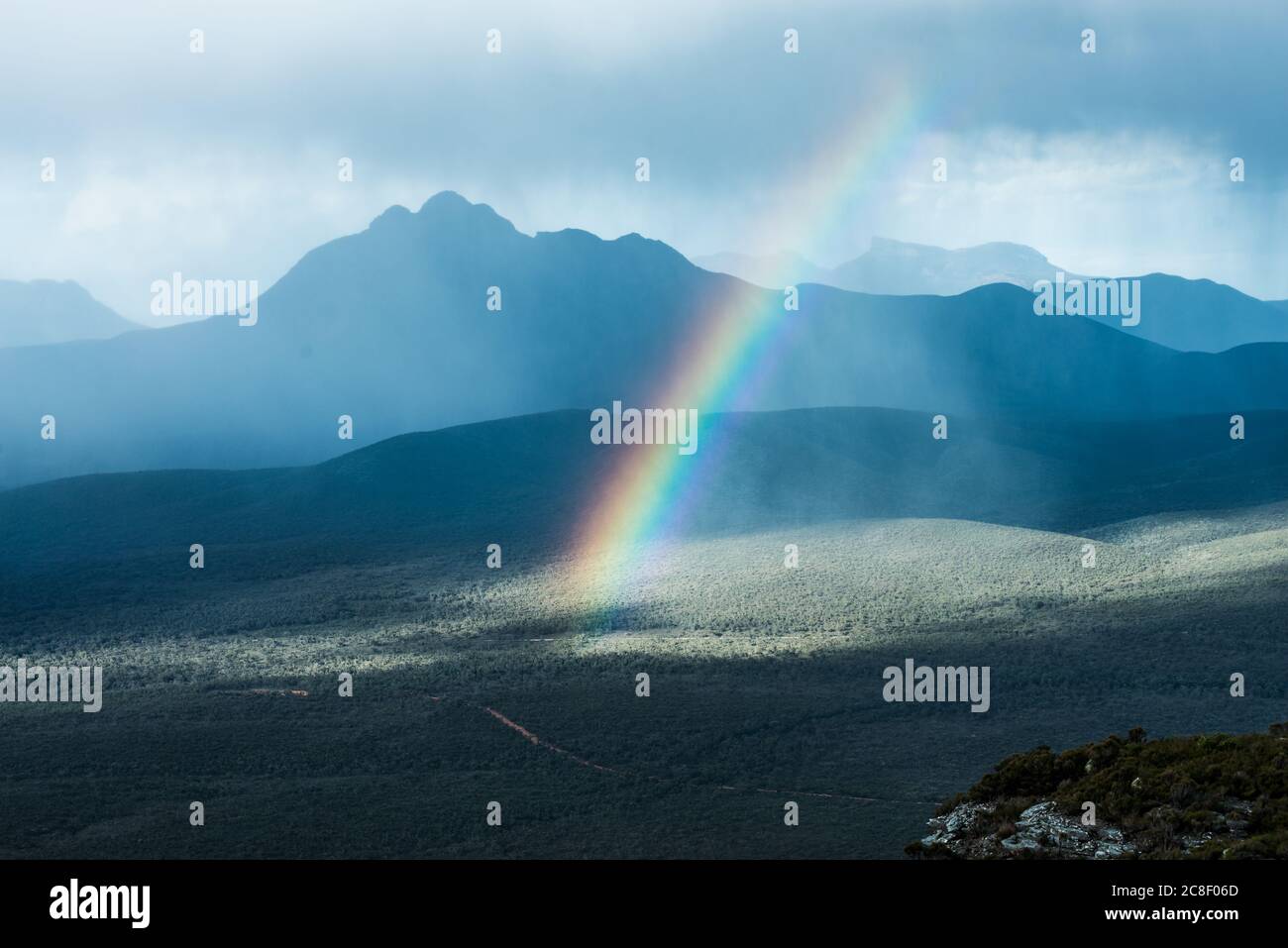 A rainbow in a storm in the Stirling range mountains, Western Australia Stock Photo