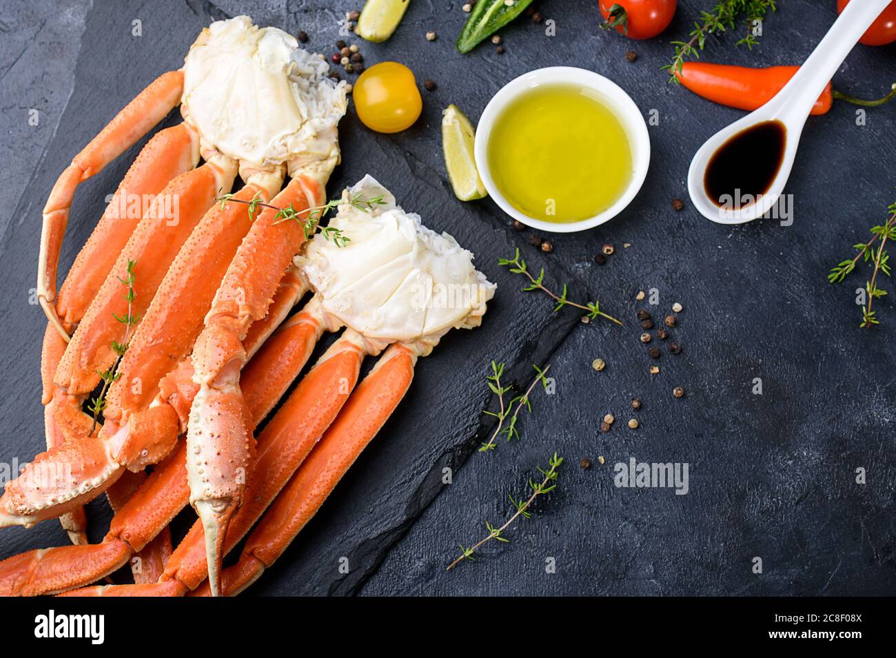 Fresh crab claws, lime, spices, spices, ice, shrimp, vegetables on a