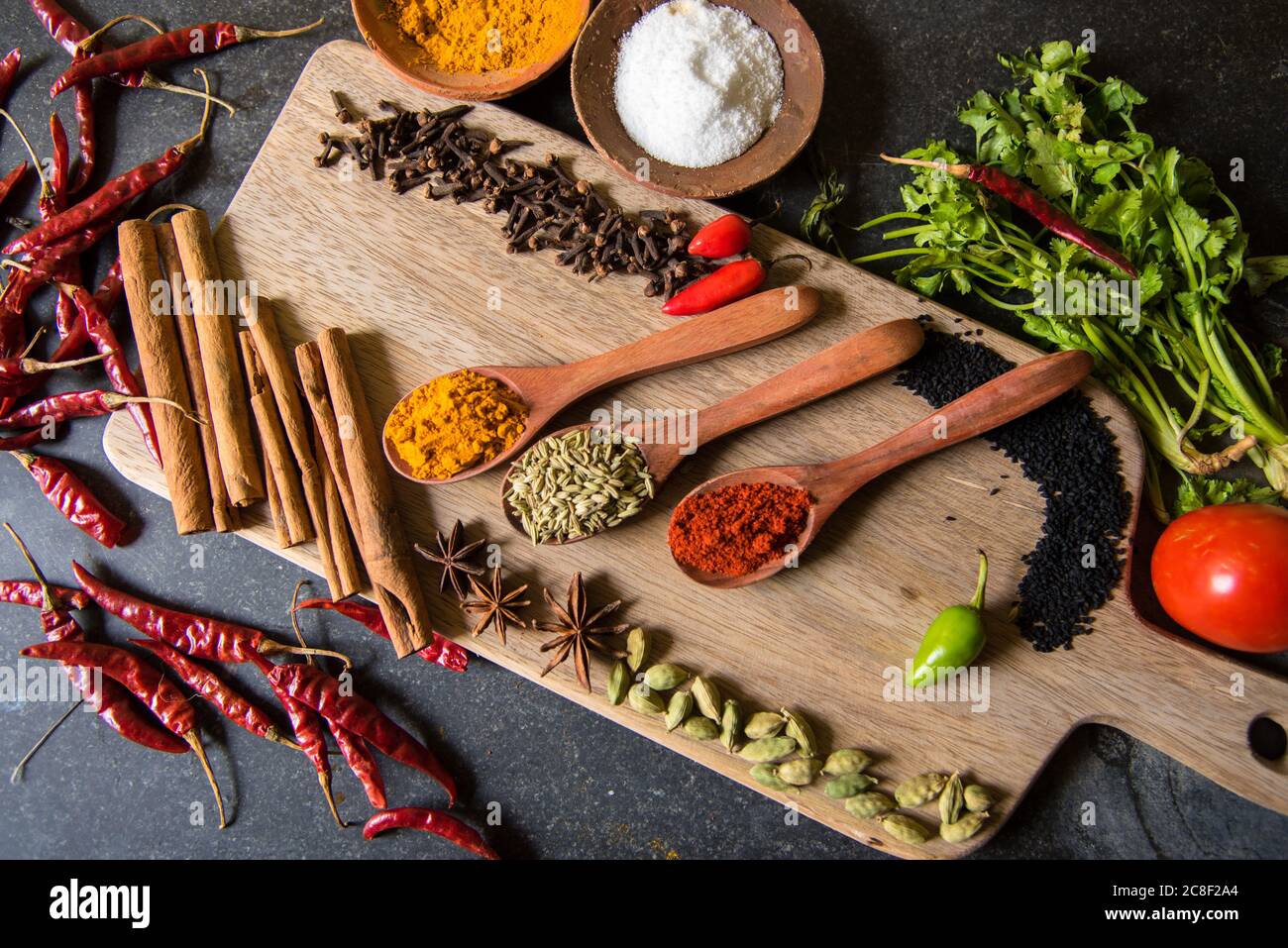 Variety of Indian spices on a wooden platter with use of selective focus Stock Photo