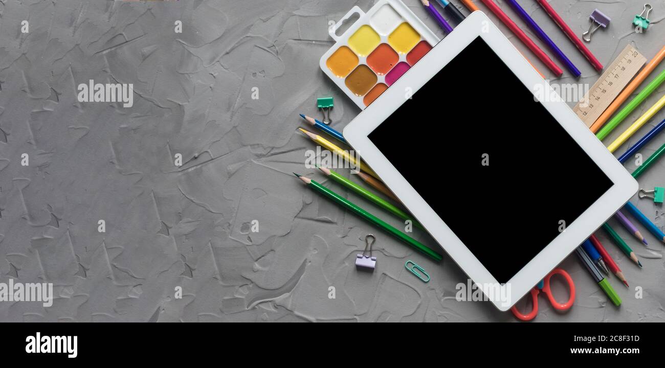 School supplies center composition on grey .concrete background Stock Photo