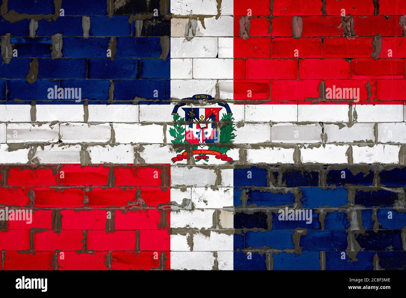 The national flag of Dominicana painted on a wall of sibit blocks with ...