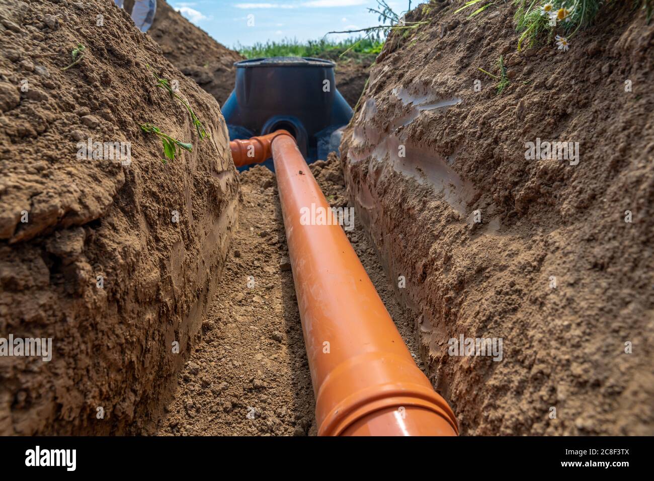 building a rainwater drainage to the collection container with the help of a plastic pipe Stock