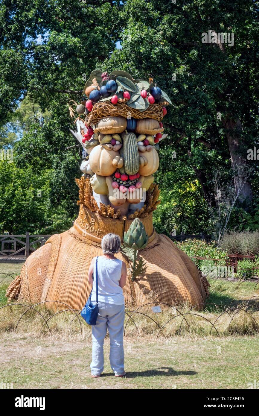 Visitor to Wisley Gardens taking a look at the Philip Haas sculpture 'Summer' Stock Photo