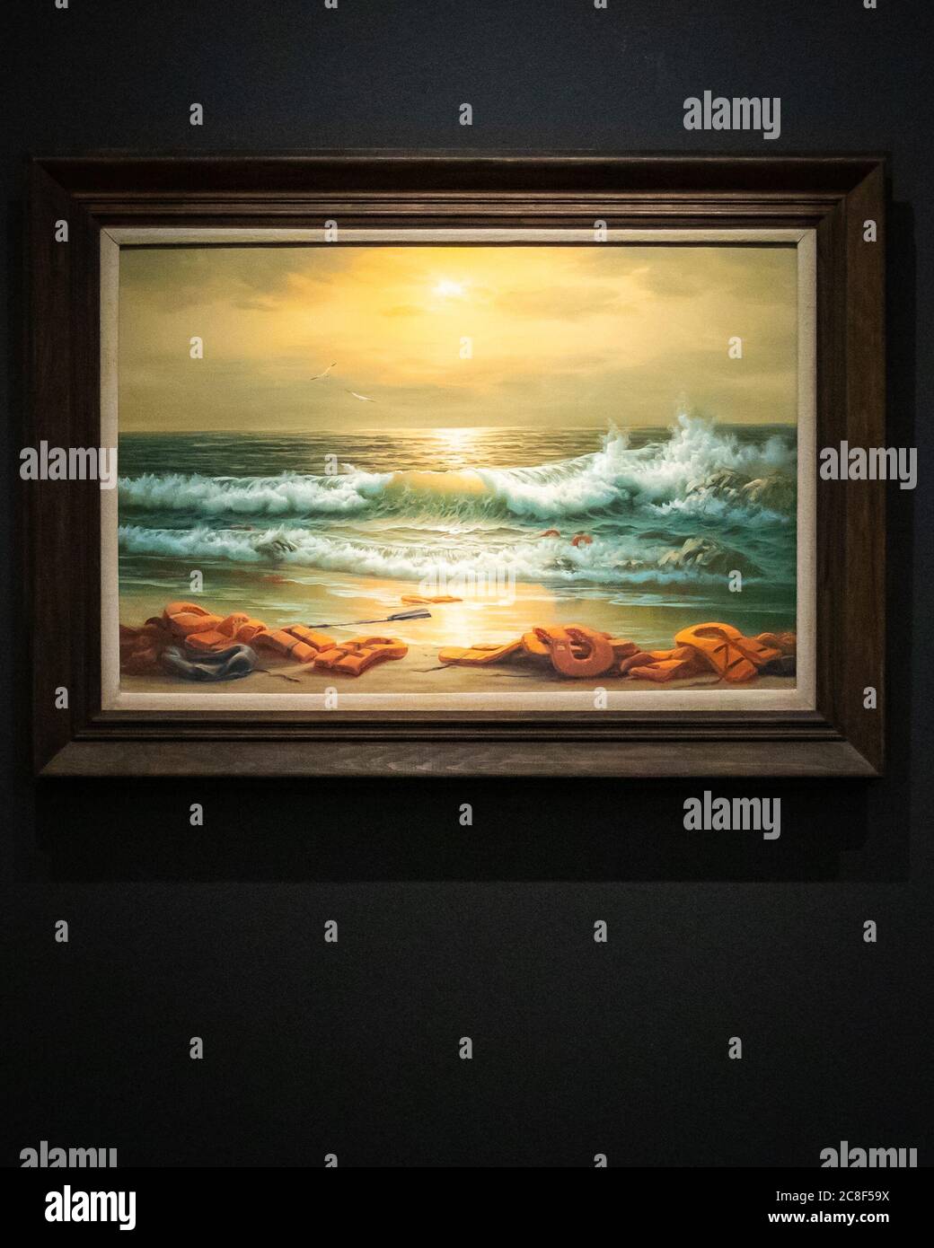 One of a triptych, Mediterranean Sea View by Banksy 2017, reworked oil paintings in artists frames in three parts with an estimate of GBP 800k -1.2 million during a press preview at Sotheby's in London ahead of their 'From Rembrandt to Richter' sale on July 28. Stock Photo