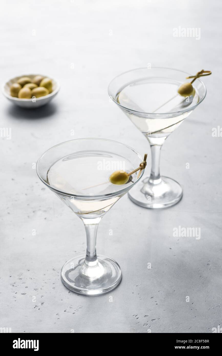 Classic Dry Martini with olives on light background, copy space