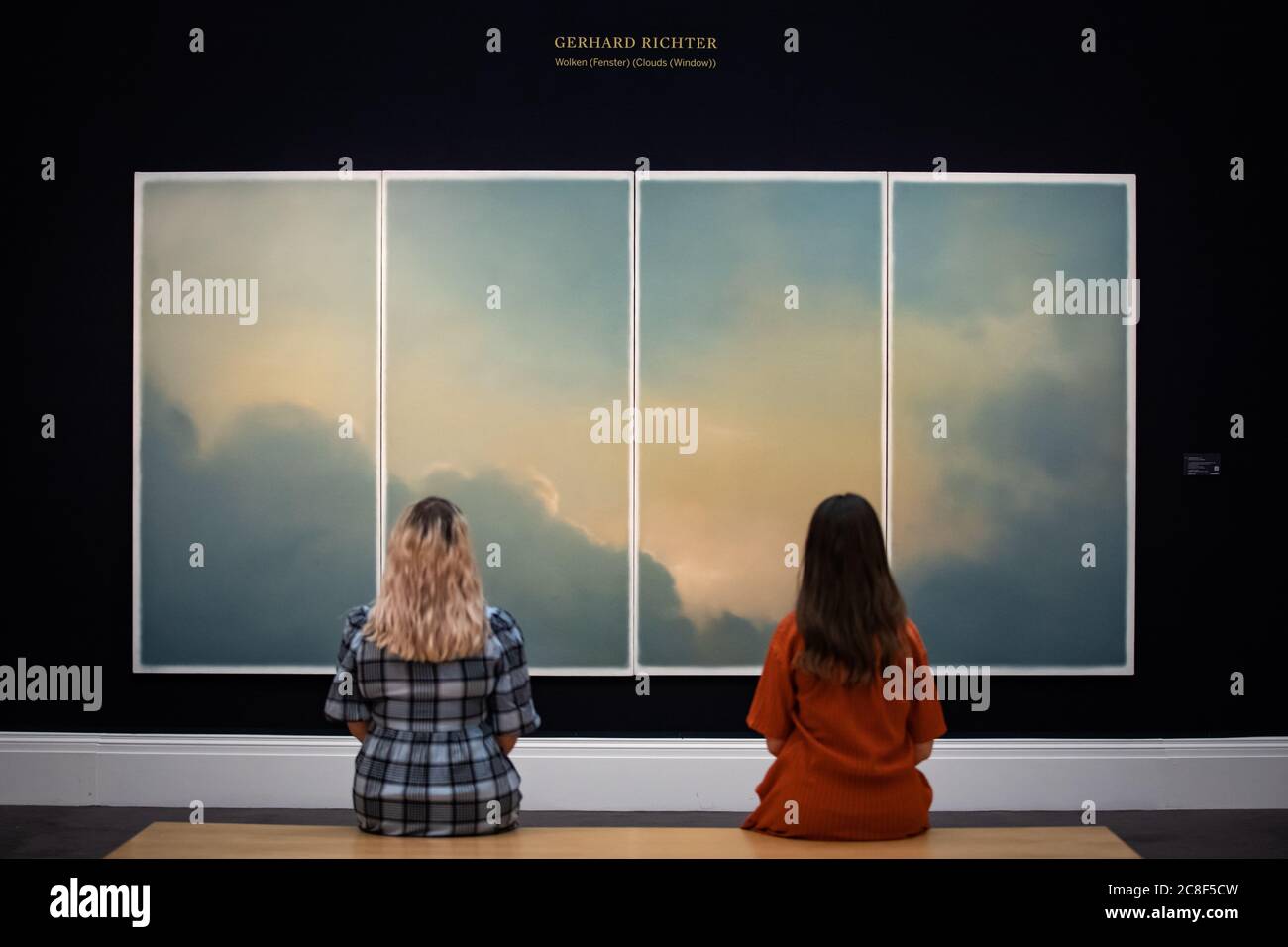 Gallery assistants in front of Wolken (fenster) (Clouds (Window)) by Gerhard Richter, 1970, oil on canvas with an estimate of GBP 9-12 million during a press preview at Sotheby's in London ahead of their 'From Rembrandt to Richter' sale on July 28. Stock Photo