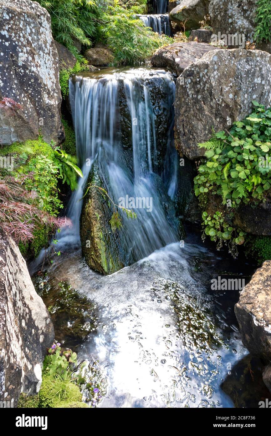 Water feature, waterfall in a rock garden Stock Photo