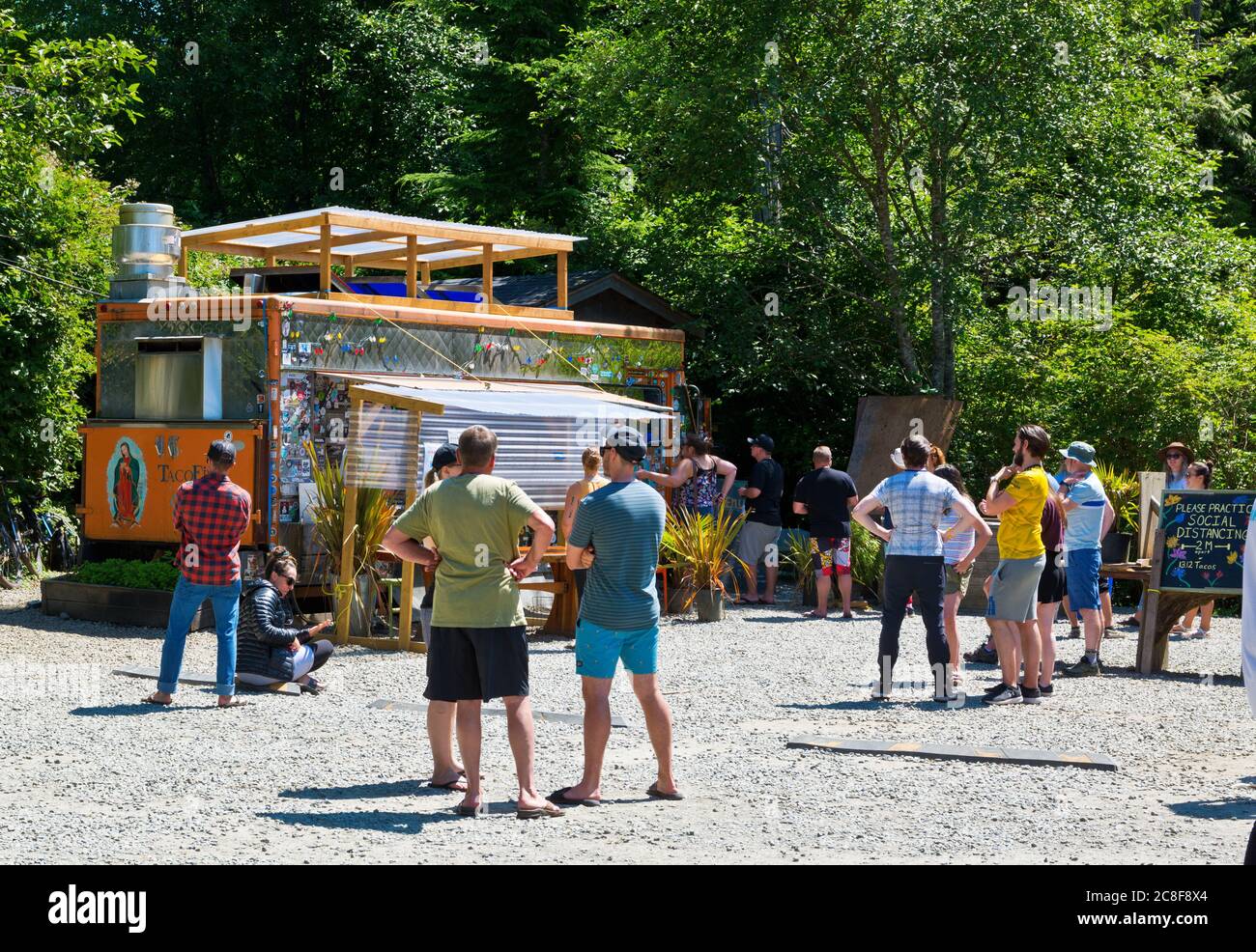 Tacofino food truck in Tofino, BC, Canada.  People waiting and practicing social distancing. Stock Photo