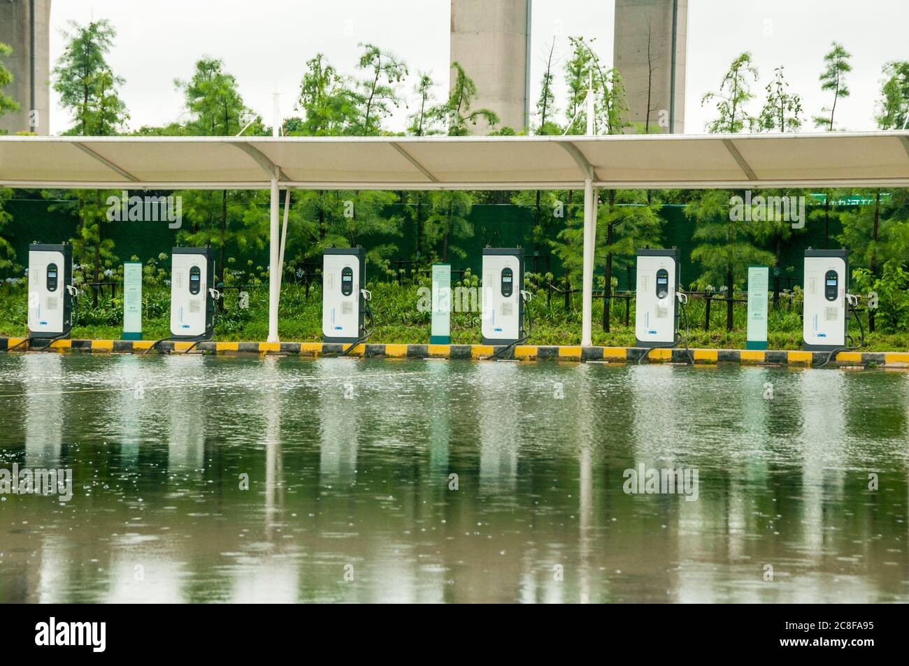 A flooded EV charging station in the shadow of the Minpu Bridge in