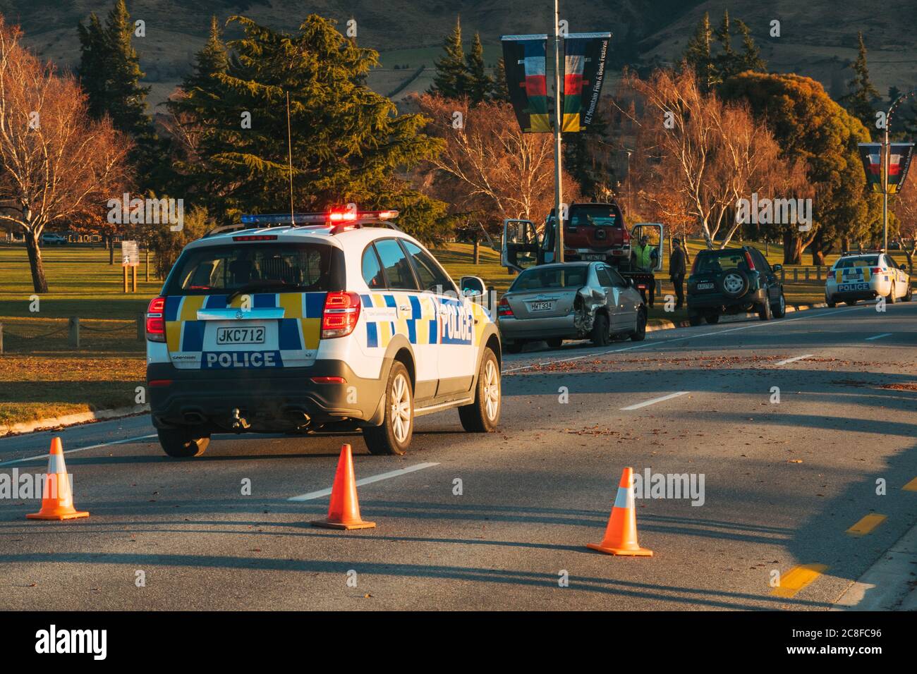 A Holden Captiva police vehicle blocks the road at a car crash in the middle of Wanaka township, New Zealand Stock Photo