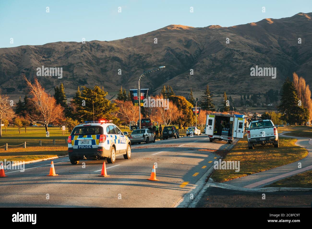 A Holden Captiva police vehicle blocks the road at a car crash in the middle of Wanaka township, New Zealand Stock Photo
