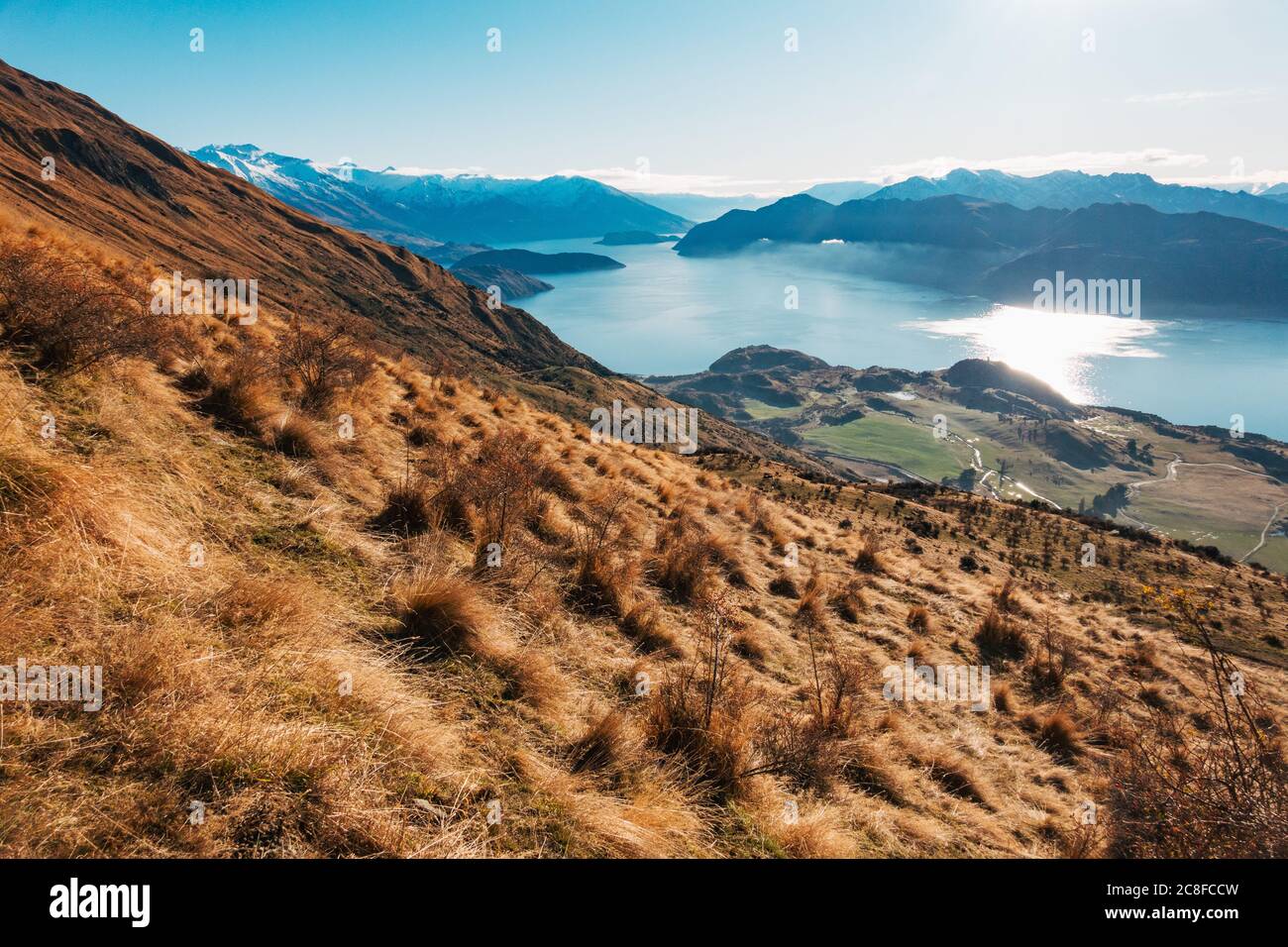 A still, blue Lake Wanaka on a winter morning in the South Island of New Zealand Stock Photo