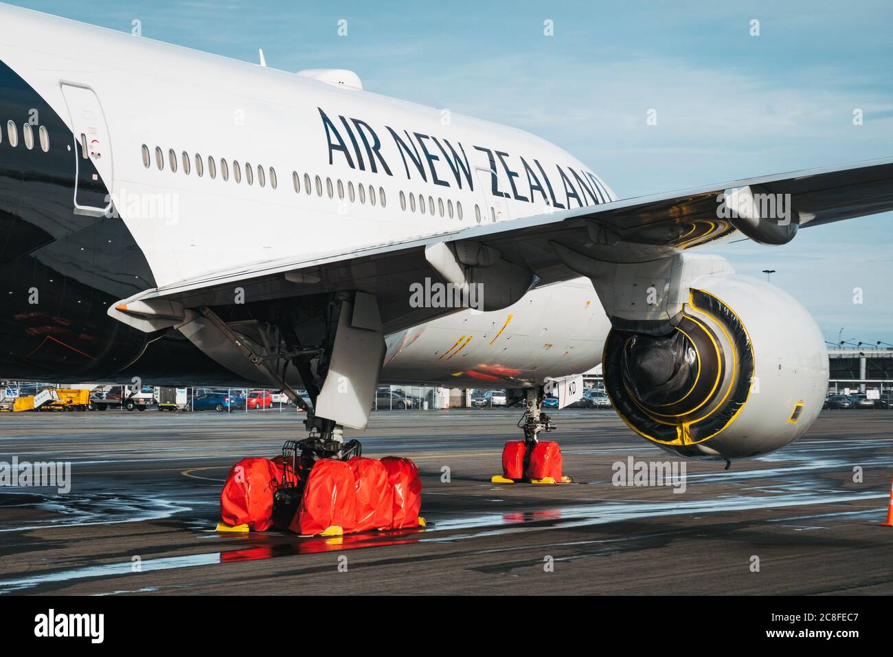A Boeing 777 in storage with wheel and engine covers in Christchurch