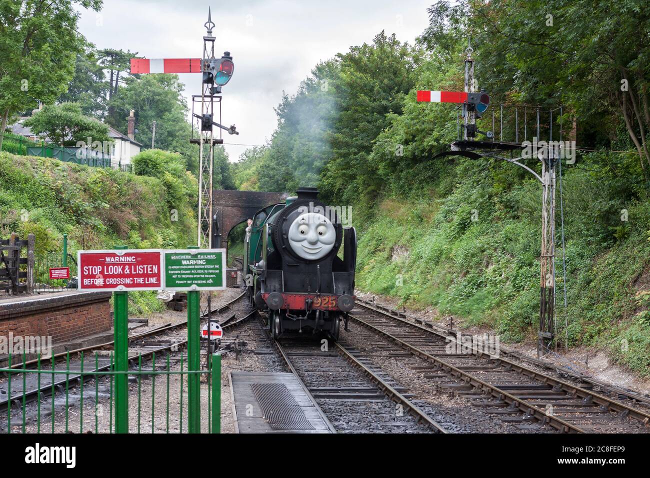 A Day Out with Thomas the Tank Engine and Friends: Schools Class steam locomotive complete with face, approaching Alresford Station on the Watercress Line Stock Photo