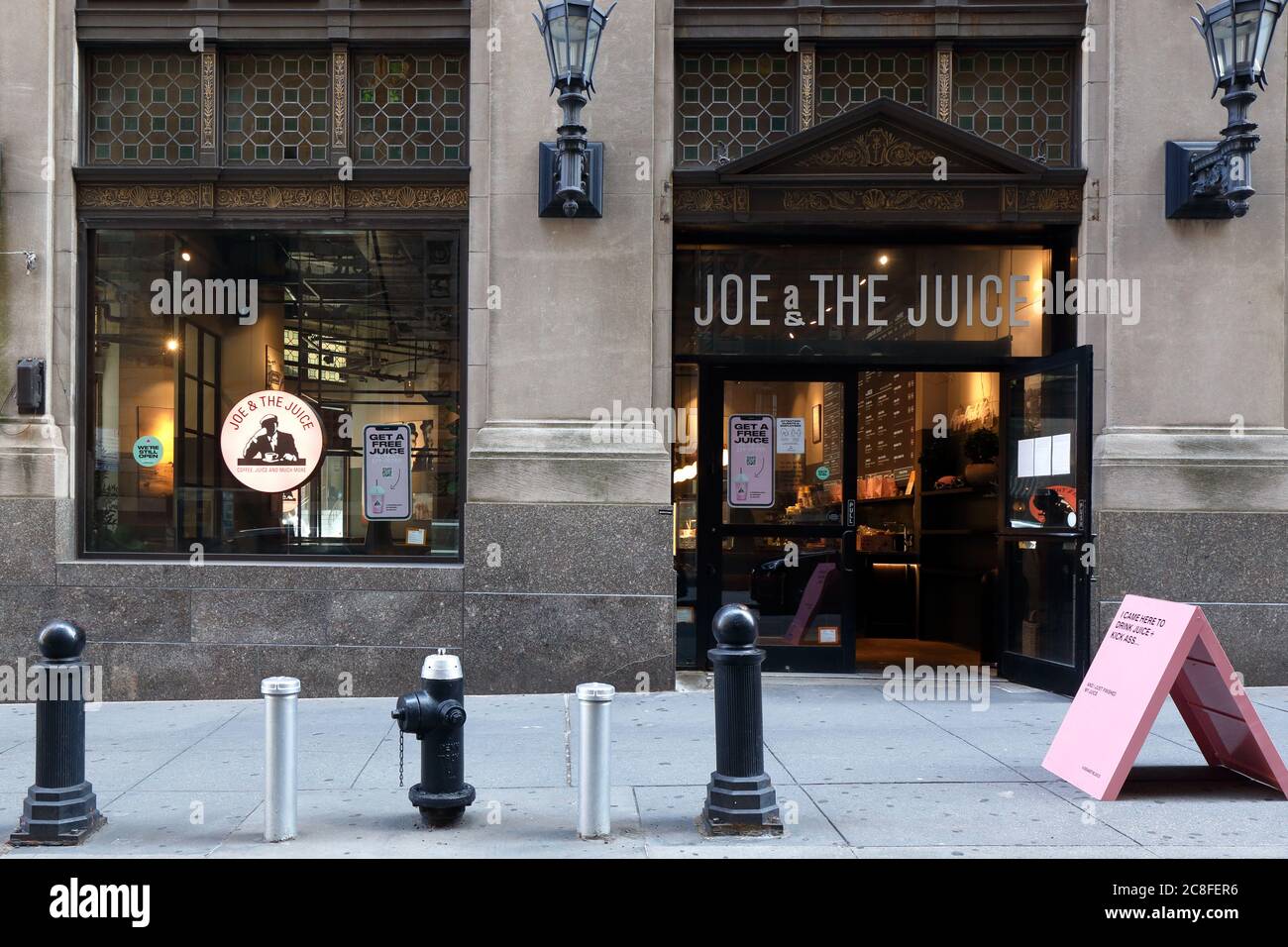 Joe & The Juice, 67 Wall St, New York, NY. exterior storefront of a juice bar and coffee shop in Manhattan's Financial District. Stock Photo
