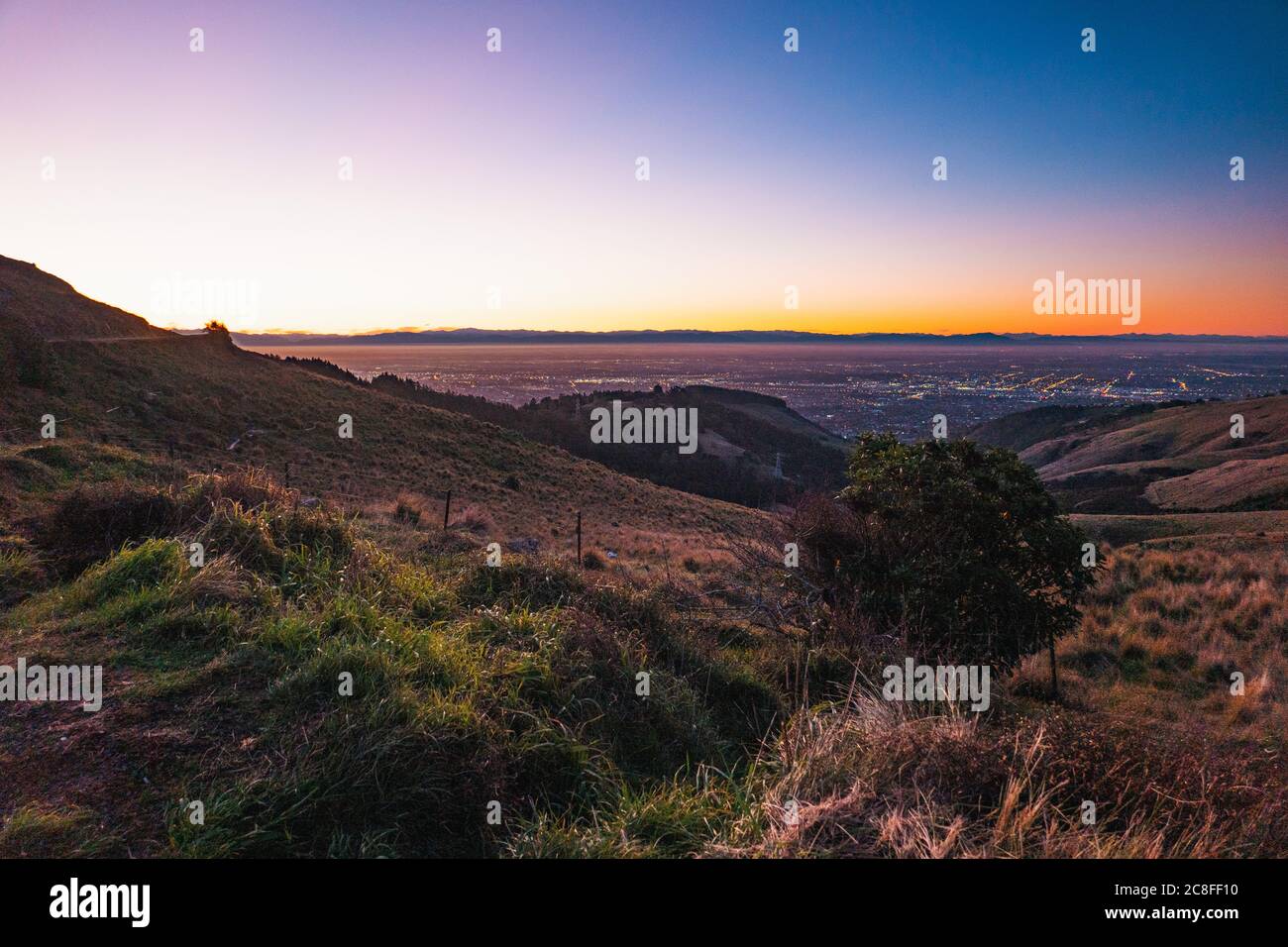 Sunset on a crystal clear evening on the Port Hills, Christchurch, New Zealand Stock Photo