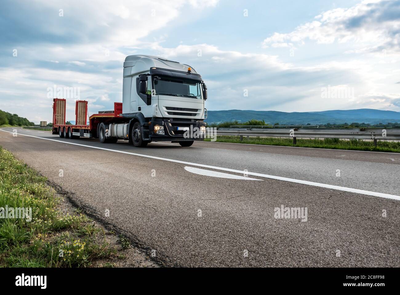 Semi trailer transportation truck with empty trailer on a highway ...