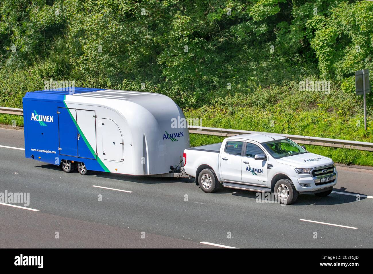 20-19 white Ford Ranger Limited 4X4 DCB TD towing Acument business caravan trailer; Vehicular traffic moving vehicles, cars driving vehicle on UK roads, hard-sided enclosed car carriers, motors, motoring on the M6 motorway highway network. Stock Photo