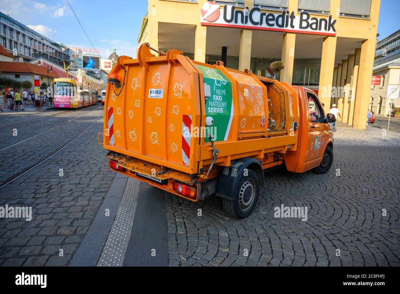 PRAGUE - JULY 20, 2019: Small orange garbage truck on the cobbled streets of the old town district of Prague Stock Photo