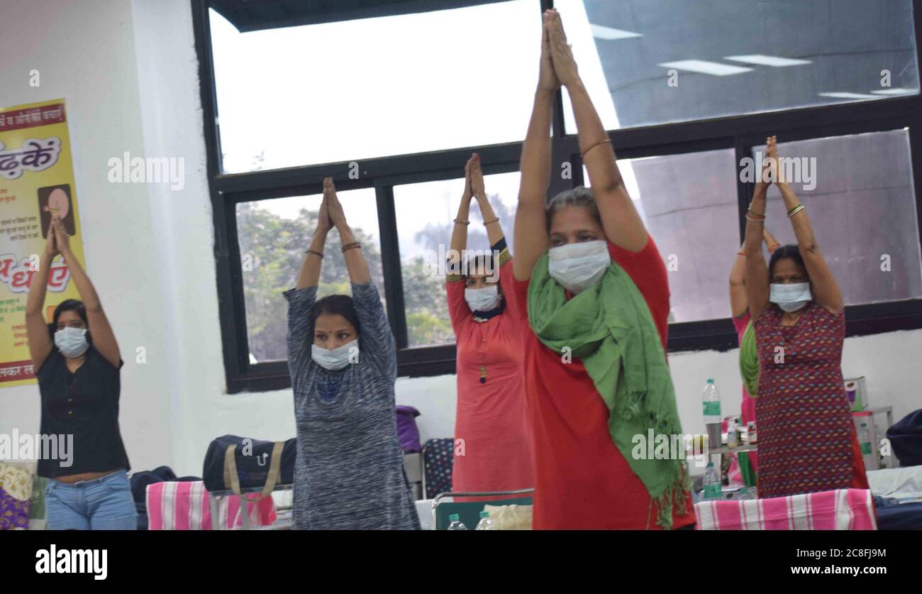 Patients undergo a yoga class inside a ward at the Commonwealth Games Village sports complex COVID centre in New Delhi, India on Friday July 24, 2020. Doctors For You, a not-for-profit organisation, supported the Delhi government in setting up the facility which has a capacity of 500 beds. Photograph: Sondeep Shankar Stock Photo