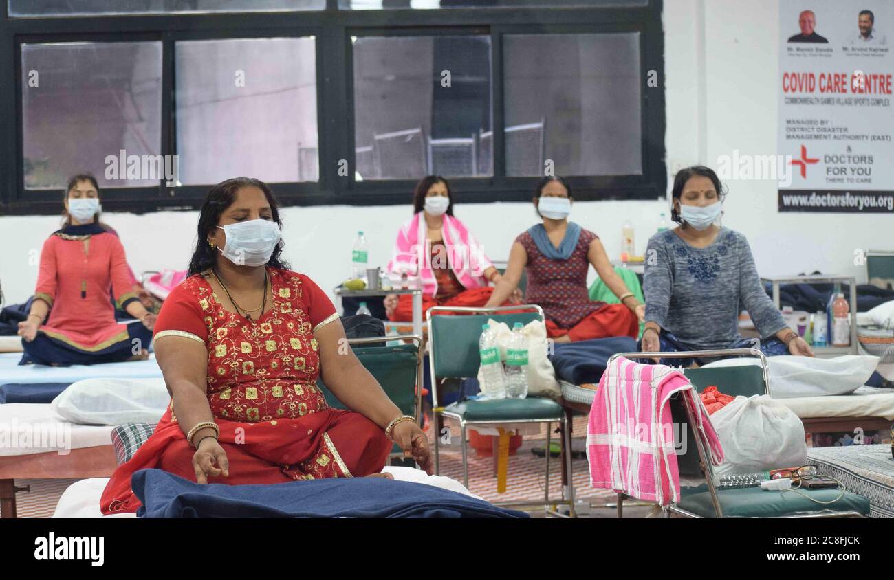 Patients suffering from coronavirus infection attend a yoga class inside a ward at the Commonwealth Games Village sports complex COVID centre in New Delhi, India on Friday July 24, 2020. Doctors For You, a not-for-profit organisation, supported the Delhi government in setting up the facility which has a capacity of 500 beds. Photograph: Sondeep Shankar Stock Photo