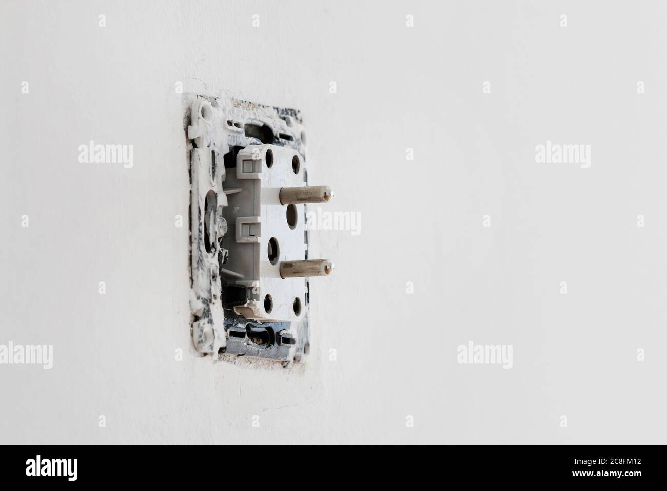 AC power plug during the instalation on the wall. Repair time Stock Photo