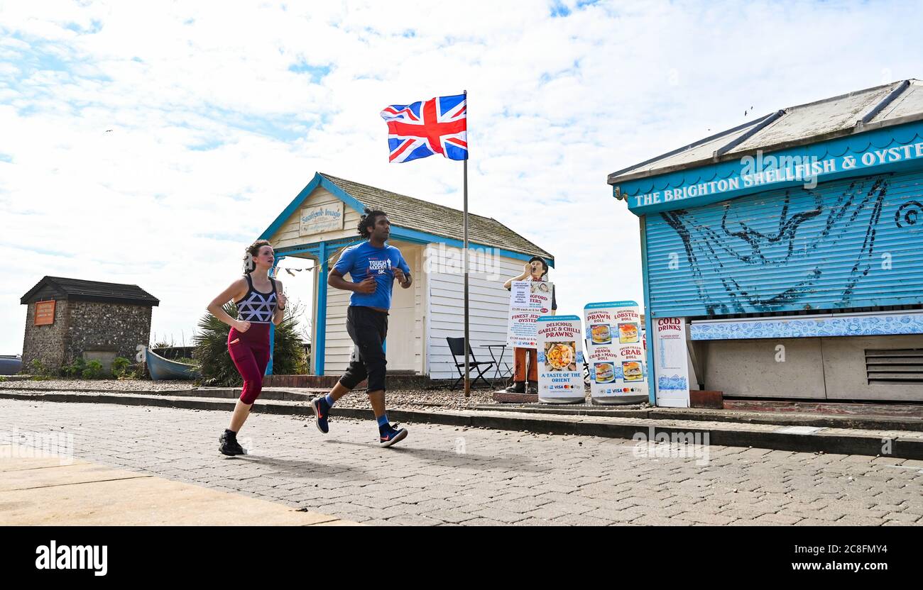 Brighton UK 24th July 2020 - Runners enjoy a hot day in Brighton with temperatures forecast to reach 25 degrees in some parts of the South East today  : Credit Simon Dack / Alamy Live News Stock Photo
