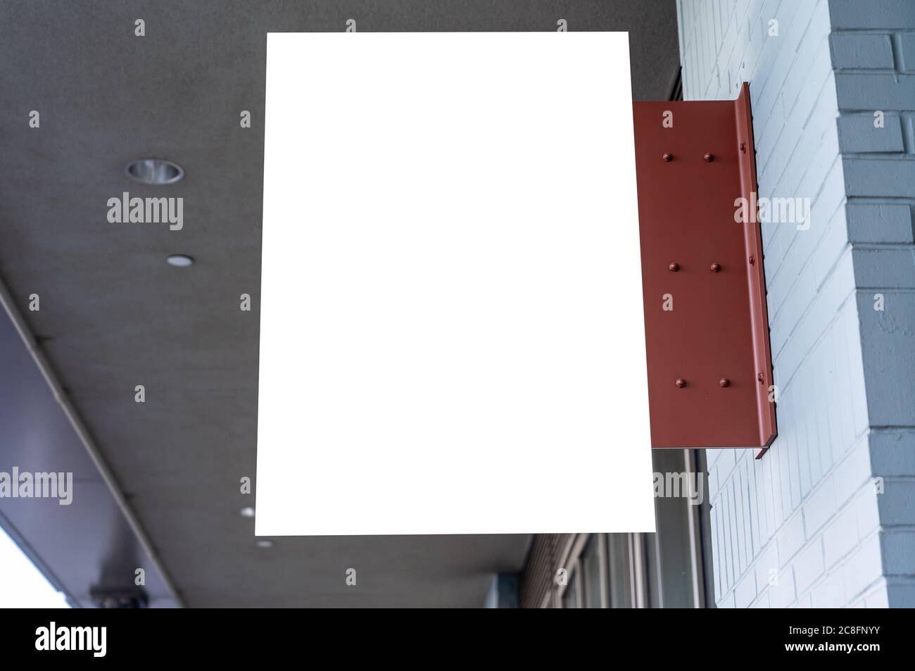 Rectangular white company sign mockup on a brick wall. Stock Photo