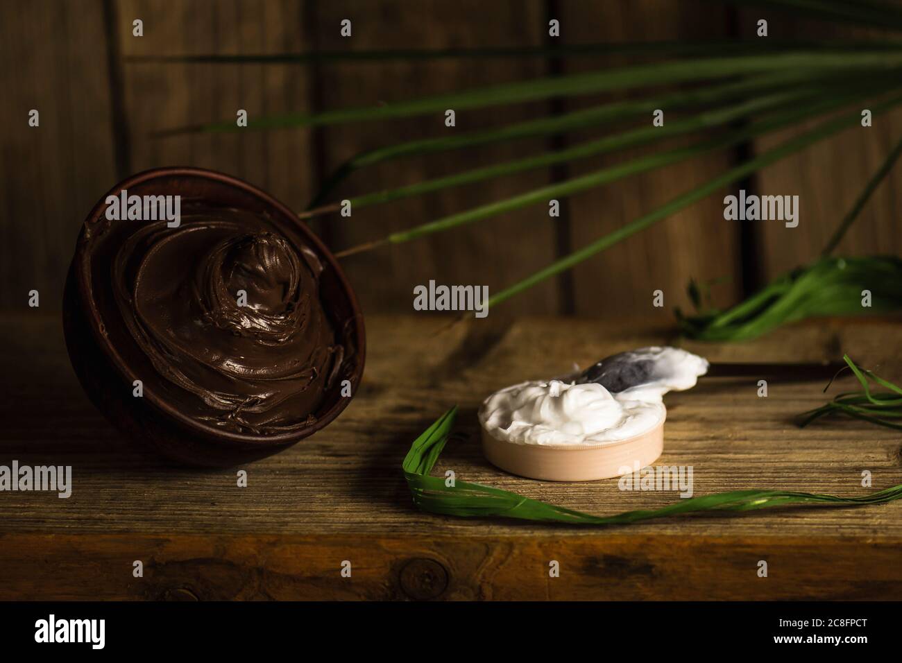 Spa chocolate concept on a wooden background. Chocolate body skin treatment. Bowl of melted chocolate Stock Photo