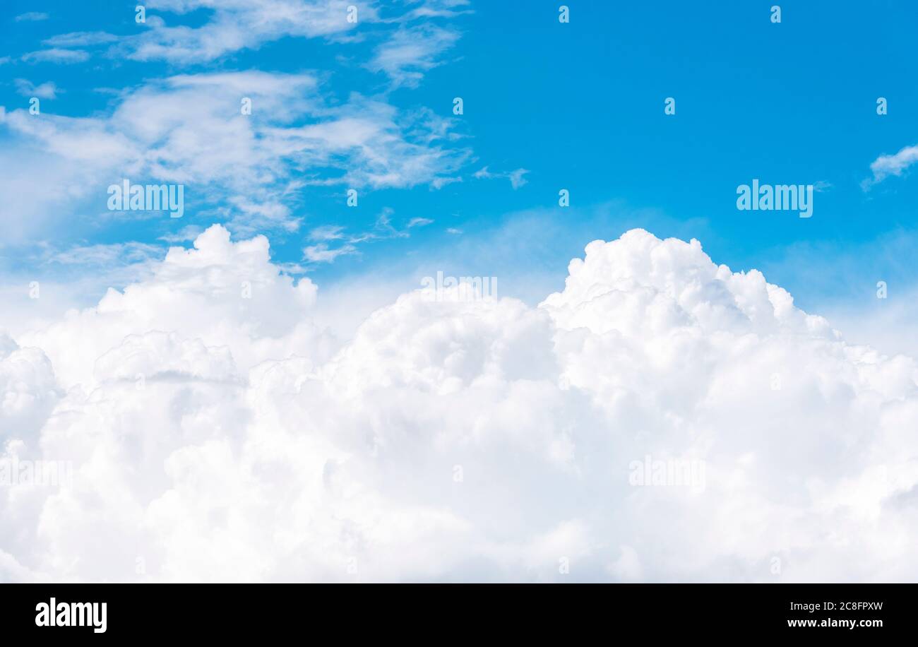 Cumulus clouds on blue sky, view from airplane window Stock Photo