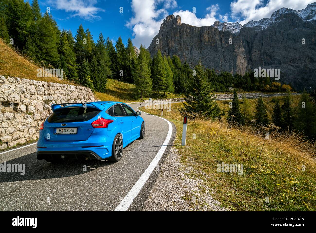 Car drives on mountain road in Dolomites, Italy. Stock Photo