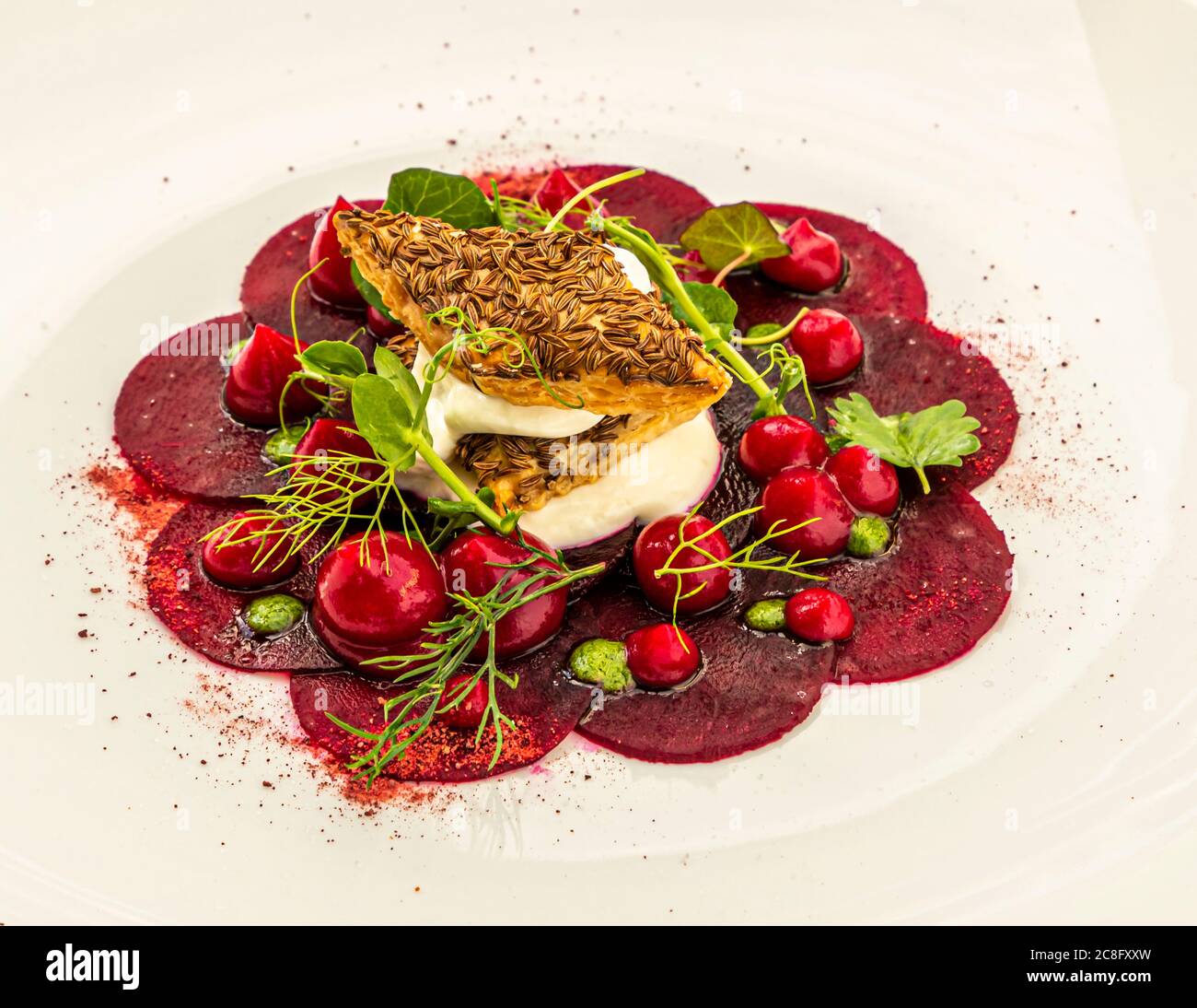 Gourmet Dish by Hotel Krone Chef de cuisine Peter Prüfer in Weil am Rhein, Germany. Kaiserstühler Rane - caraway pastry, sour cream and wild herbs Stock Photo