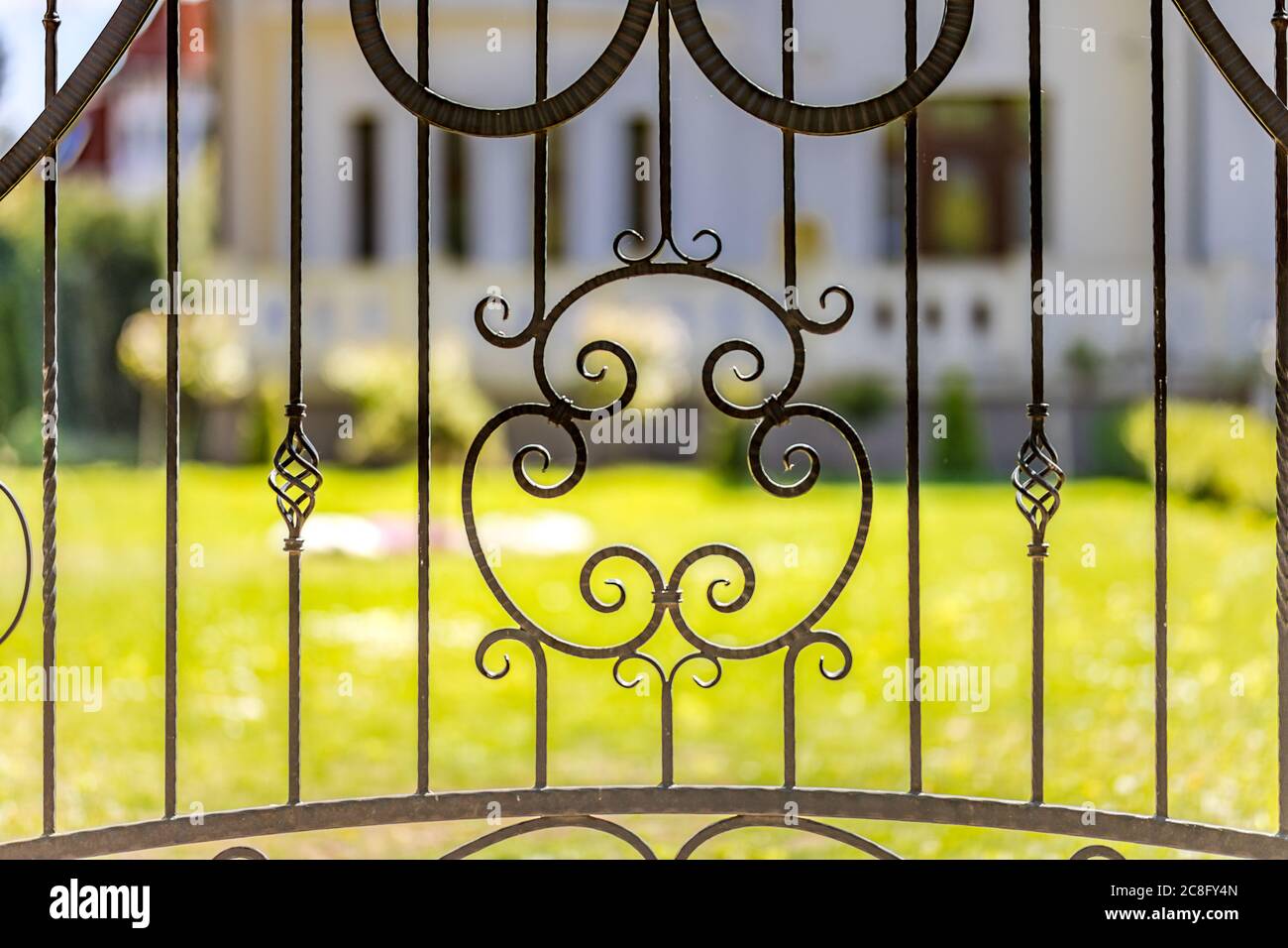 Wrought iron tracery black fence fragment. Elegant decorative cast iron fence. Stock Photo