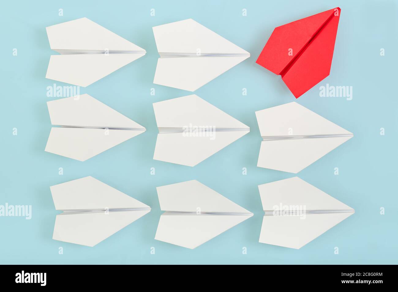 being different concept with red paper plane going in a different direction Stock Photo