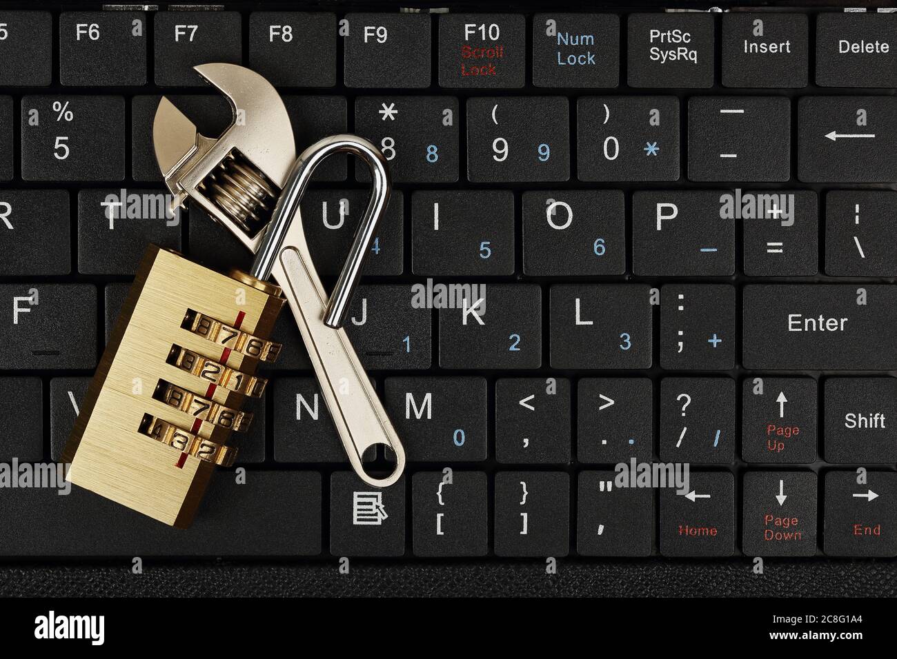 padlock and wrench on computer keyboard, internet security and repair concept Stock Photo