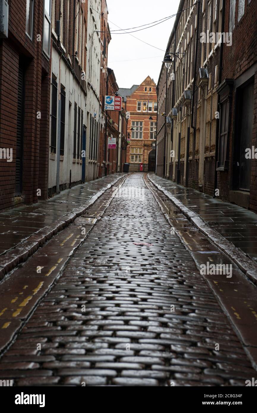 A wet dark cobbled alley. Stock Photo